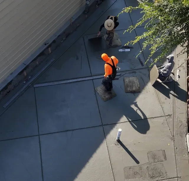 Drone view of the crew hand-finishing a concrete slab