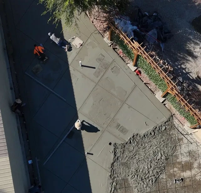 Drone view of a freshly placed concrete slab being finished